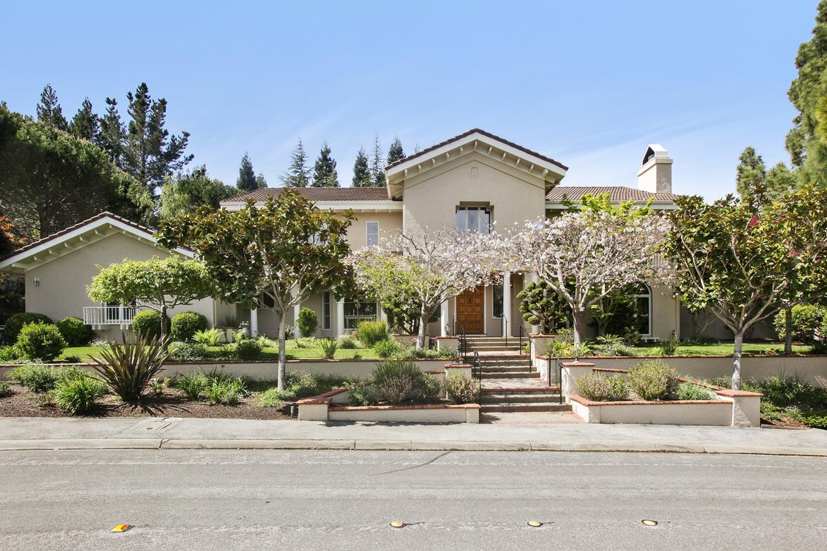 a front view of a house with a garden