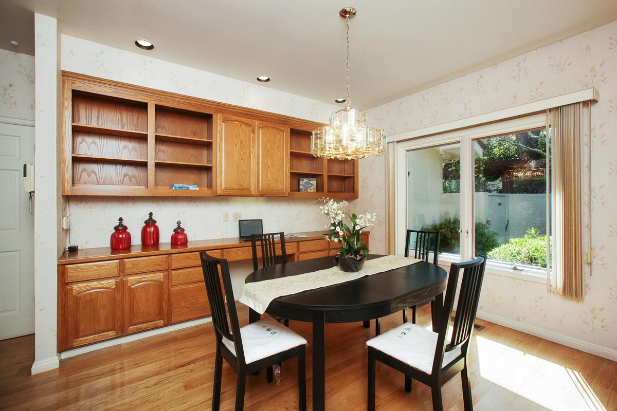 Stonepine Road Hillsborough, CA 94010 - Photo 11 of 25 a dining room with a wooden table and chairs