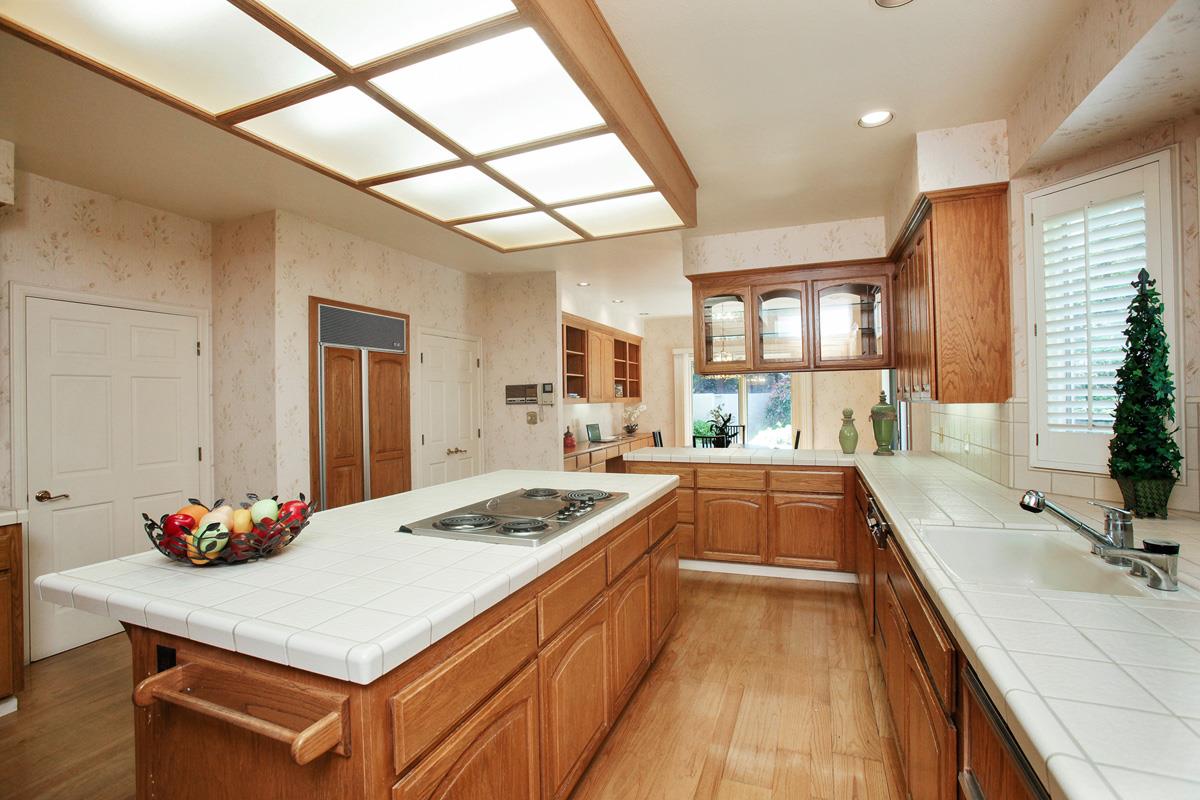 Stonepine Road Hillsborough, CA 94010 - Photo 14 of 25 a kitchen with a sink stove and cabinets