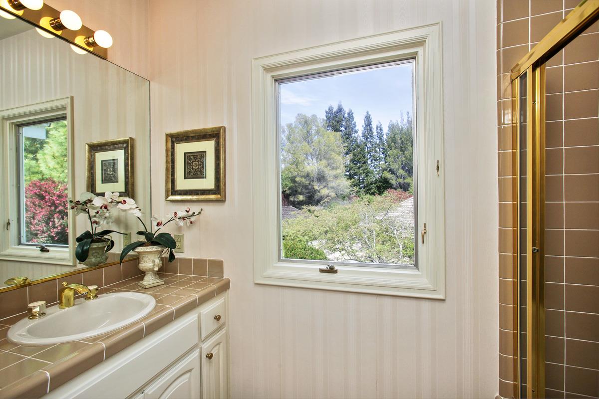 Stonepine Road Hillsborough, CA 94010 - Photo 17 of 25 a bathroom with a granite countertop sink a large mirror and a shower
