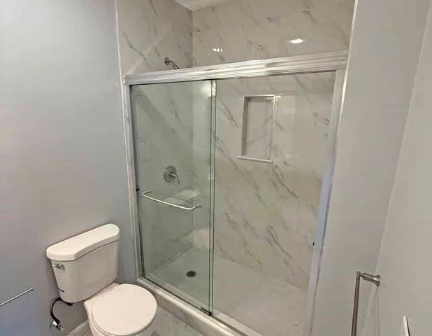 a bathroom with a shower and a toilet