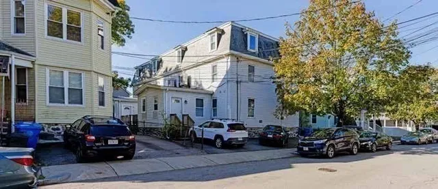 a car parked in front of a white building