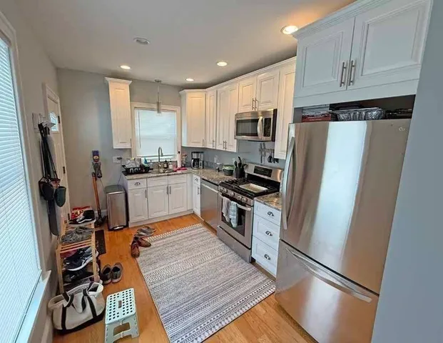 a kitchen with stainless steel appliances a refrigerator stove microwave and sink