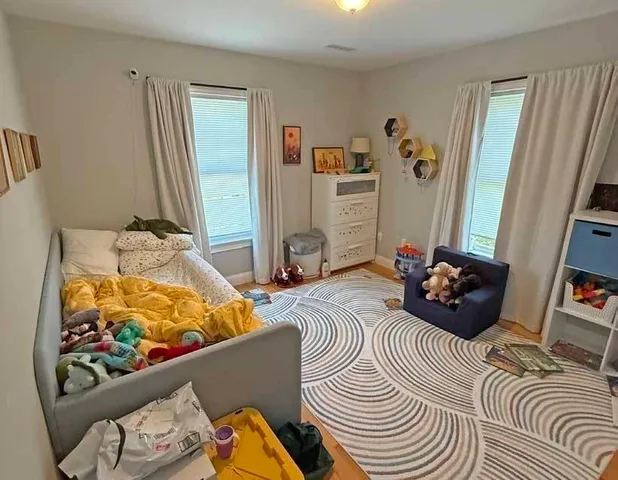 a bedroom with bed and a window