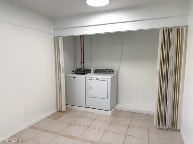 585 14th Street North Naples, FL 34102 - Photo 11 of 24 a utility room with cabinets washer and dryer