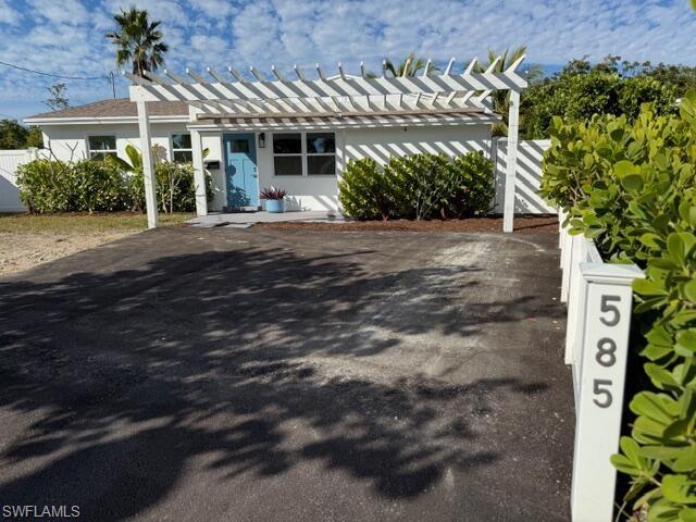 585 14th Street North Naples, FL 34102 - Photo 2 of 24 a front view of a house with a yard