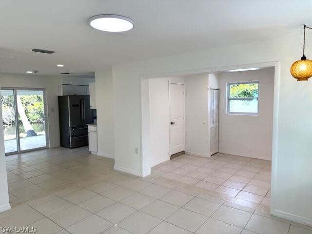 585 14th Street North Naples, FL 34102 - Photo 6 of 24 an empty room with windows and entrance