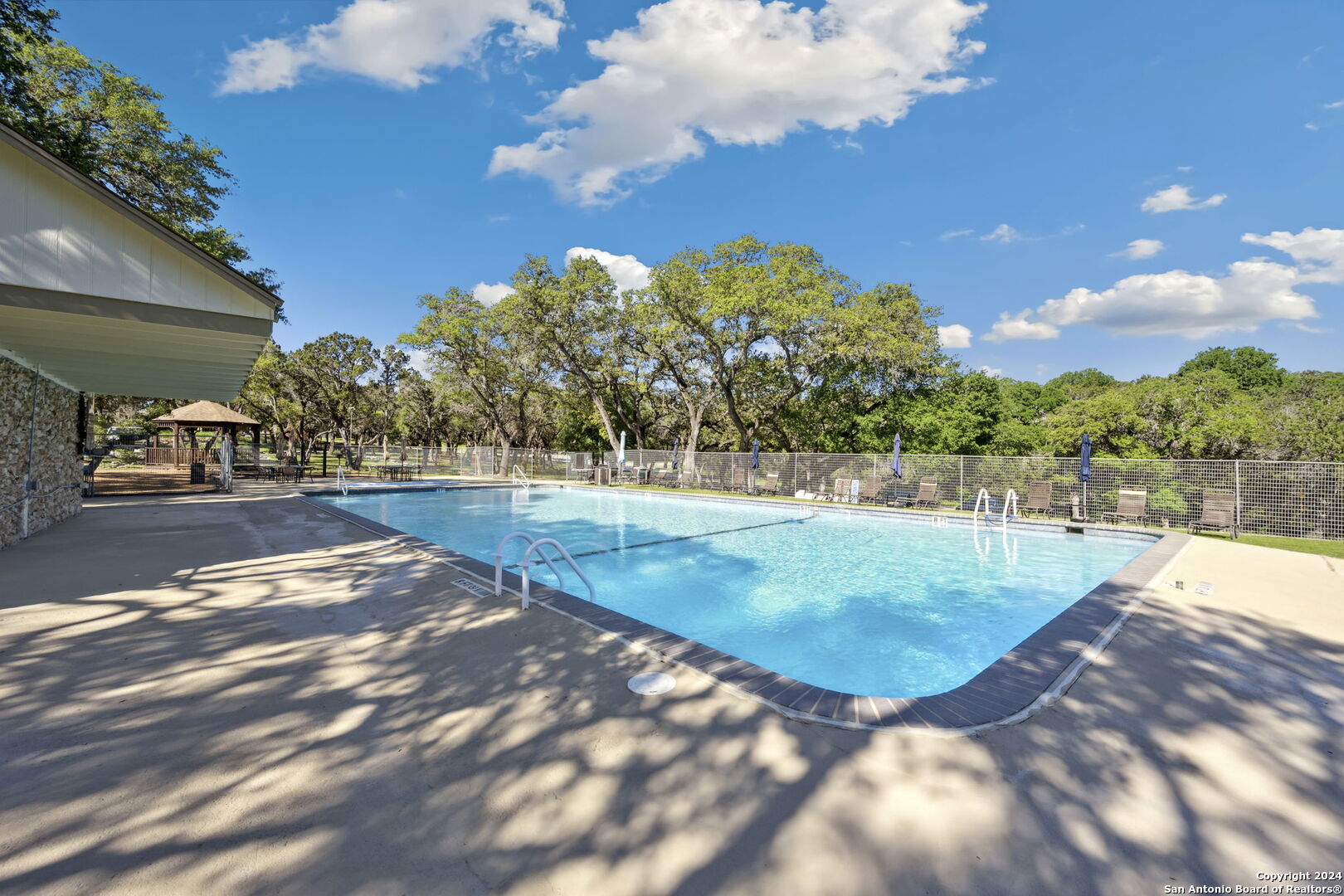 1268 Overbrook Lane Spring Branch, TX 78070 - Photo 17 of 20 a view of a swimming pool with an outdoor seating
