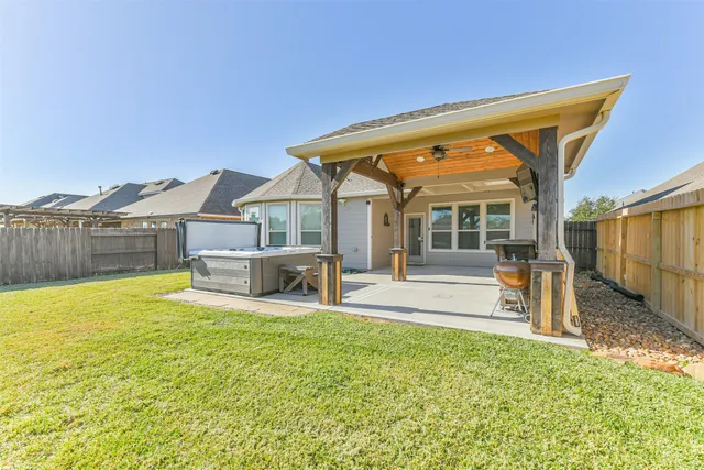 a view of a house with a backyard porch and furniture