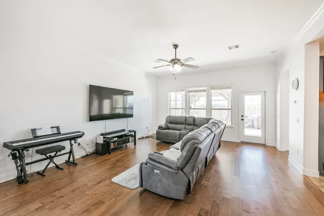 a living room with furniture and a flat screen tv