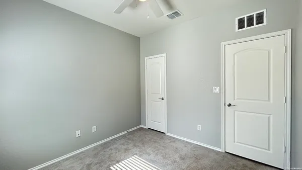 an empty room with windows and closet