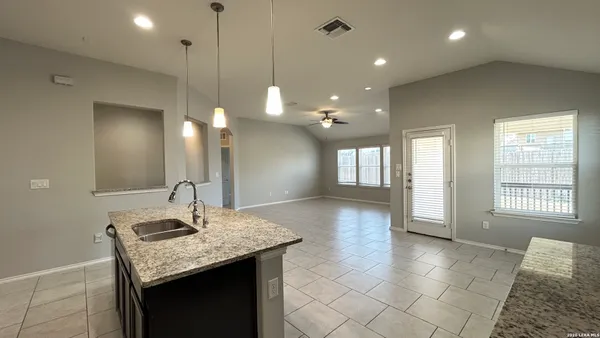 a bathroom with a granite countertop sink a large mirror and vanity