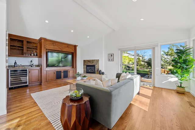 a dining room with wooden floor and chandelier
