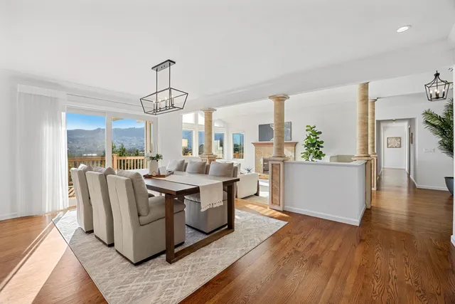 a spacious bedroom with a bed a couch and a potted plant