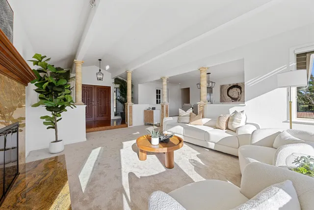 a spacious en suite bathroom with a granite countertop sink mirror and bathtub