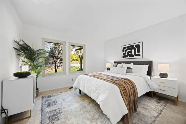 a view of a roof deck with table and chairs and wooden floor