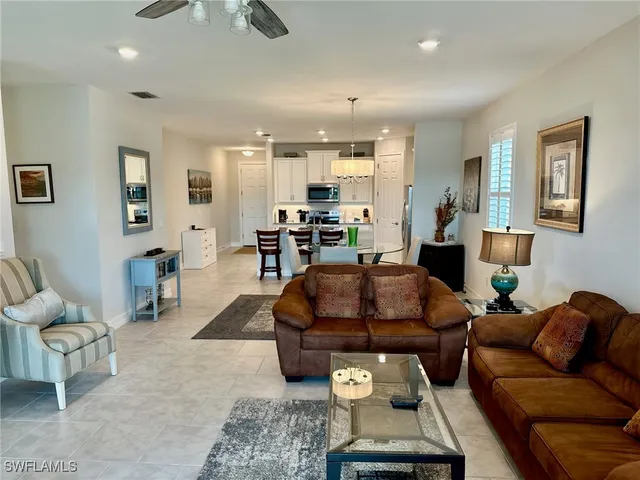 a living room with furniture and kitchen view