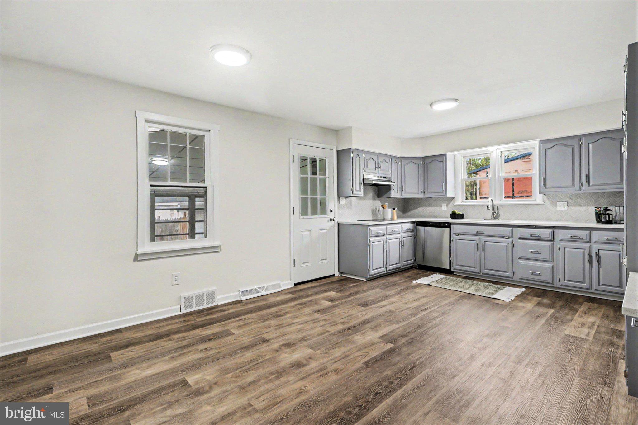 708 Baltimore Road Shippensburg, PA 17257 - Photo 6 of 24 a kitchen with wooden floors and white cabinets
