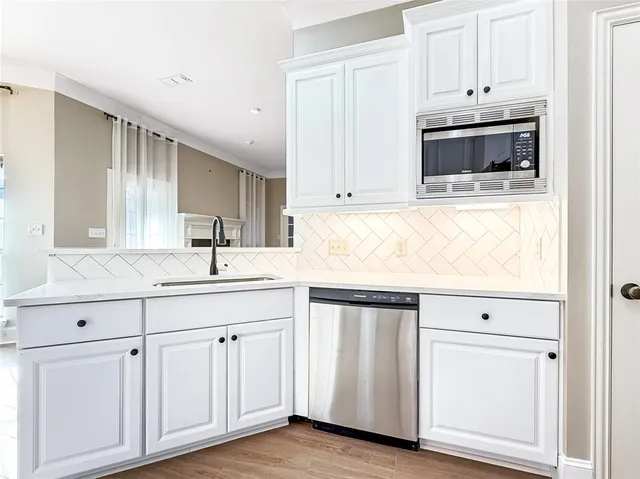 a kitchen with white cabinets and white appliances