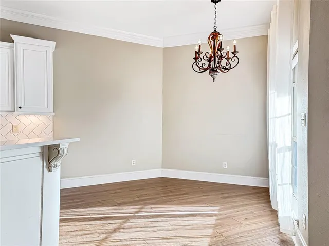 a view of a room with wooden floor and utility room