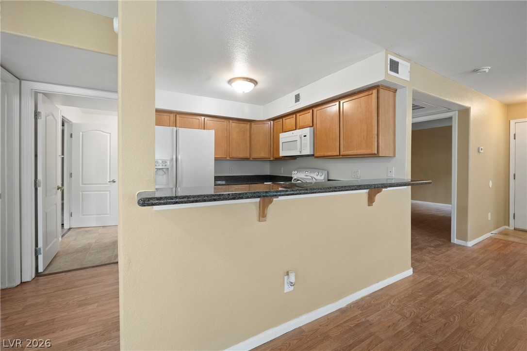 3145 East Flamingo Road, Unit 1055 Las Vegas, NV 89121 - Photo 14 of 40 A well-appointed kitchen features ample cabinetry and a convenient breakfast bar, perfect for casual dining.