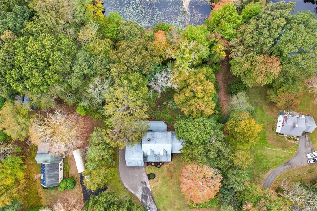 an aerial view of a house with swimming pool and garden