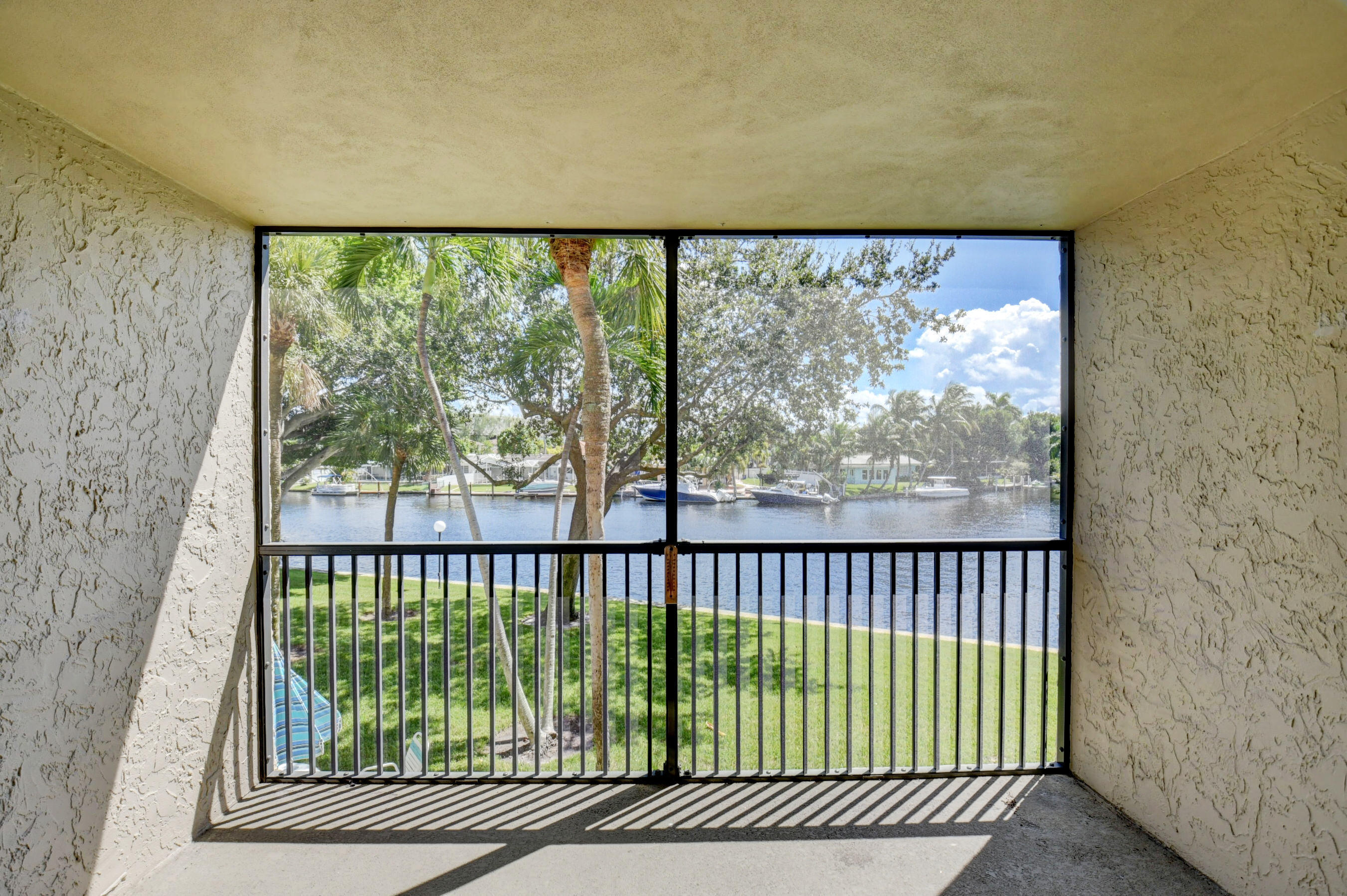 14 Royal Palm Way, Unit 2050 Boca Raton, FL 33432 - Photo 15 of 44 a view of a back yard from a window
