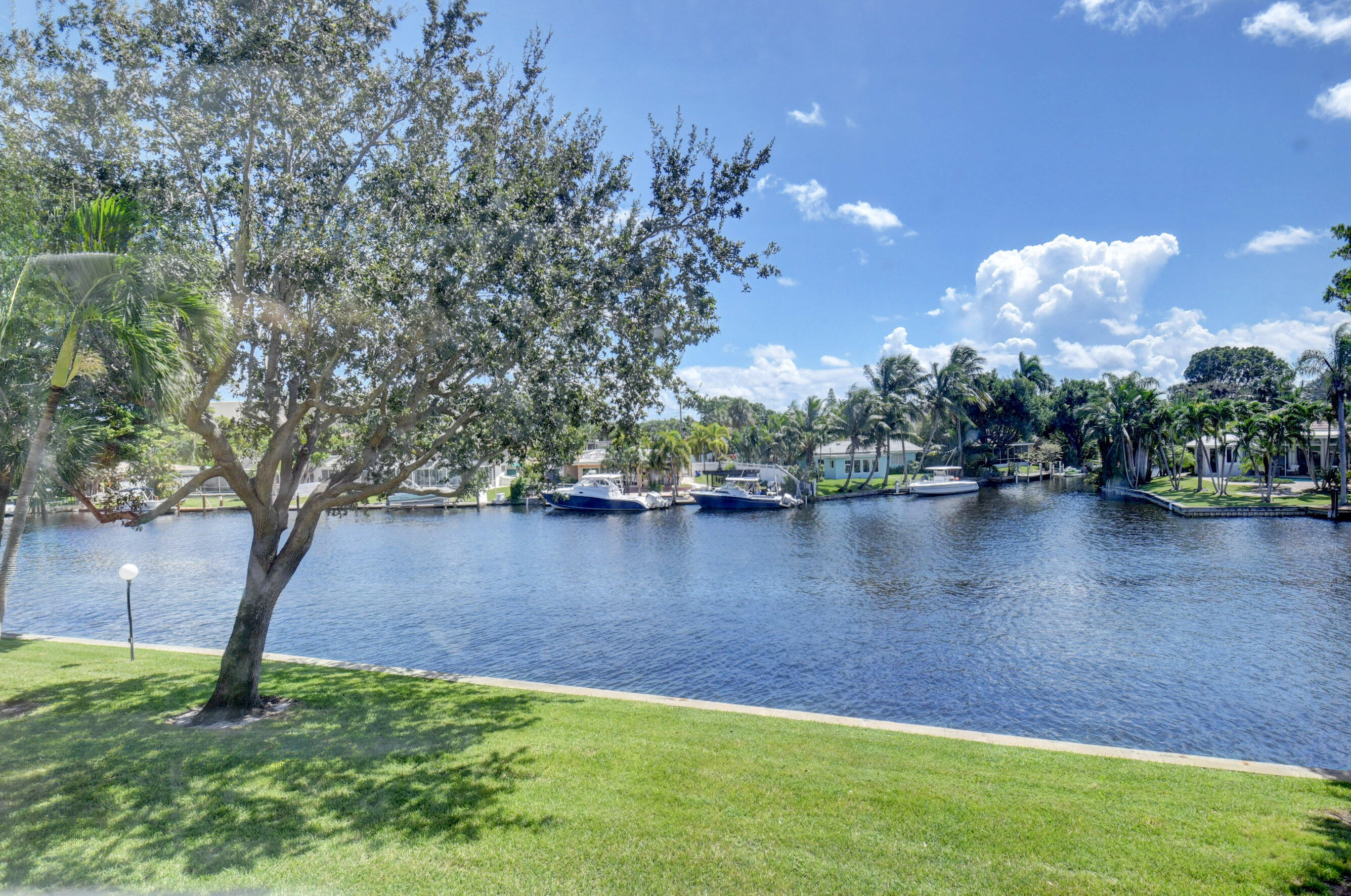 14 Royal Palm Way, Unit 2050 Boca Raton, FL 33432 - Photo 17 of 44 a view of a lake with houses