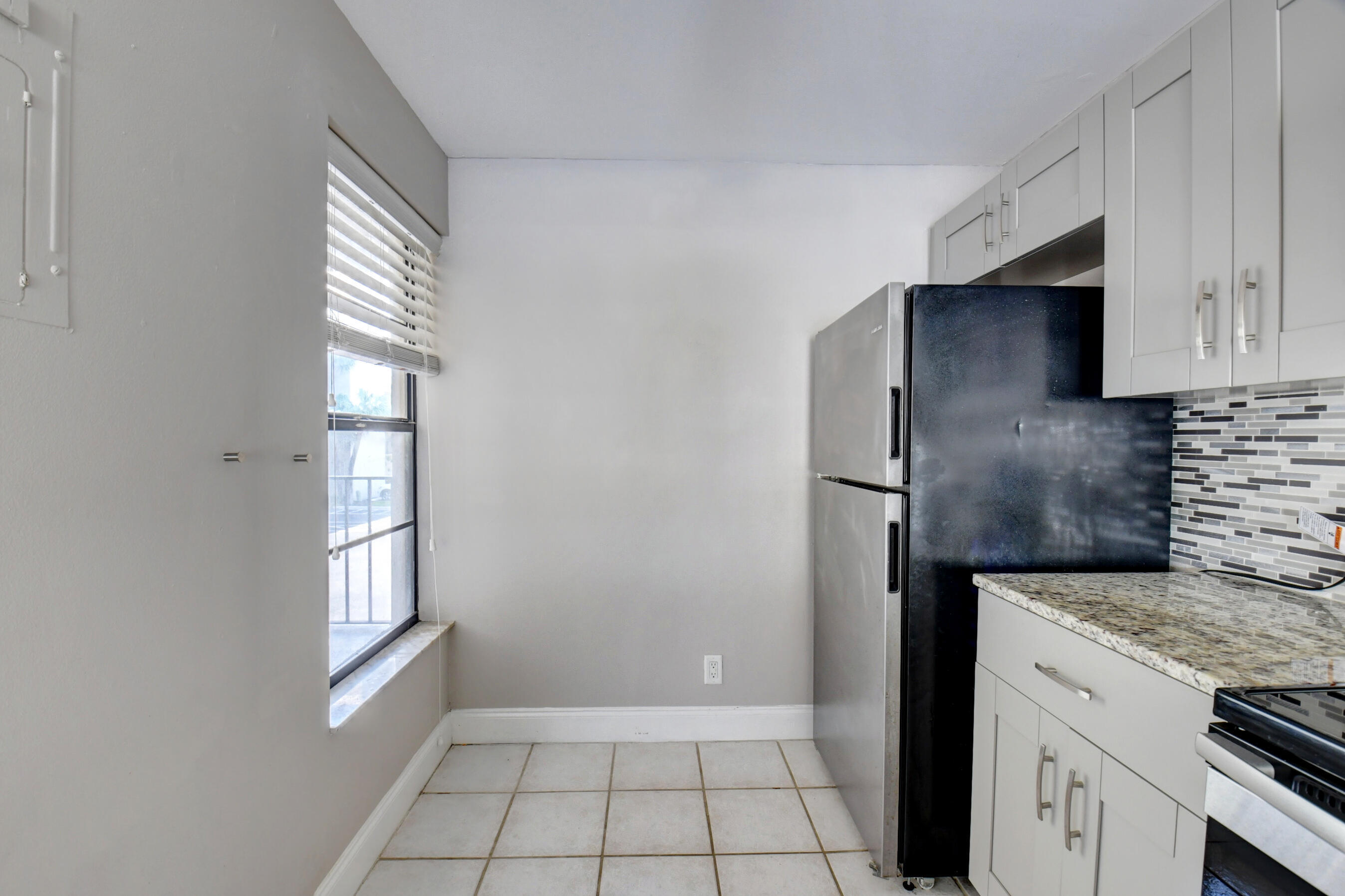 14 Royal Palm Way, Unit 2050 Boca Raton, FL 33432 - Photo 19 of 44 a kitchen with a refrigerator and a stove top oven