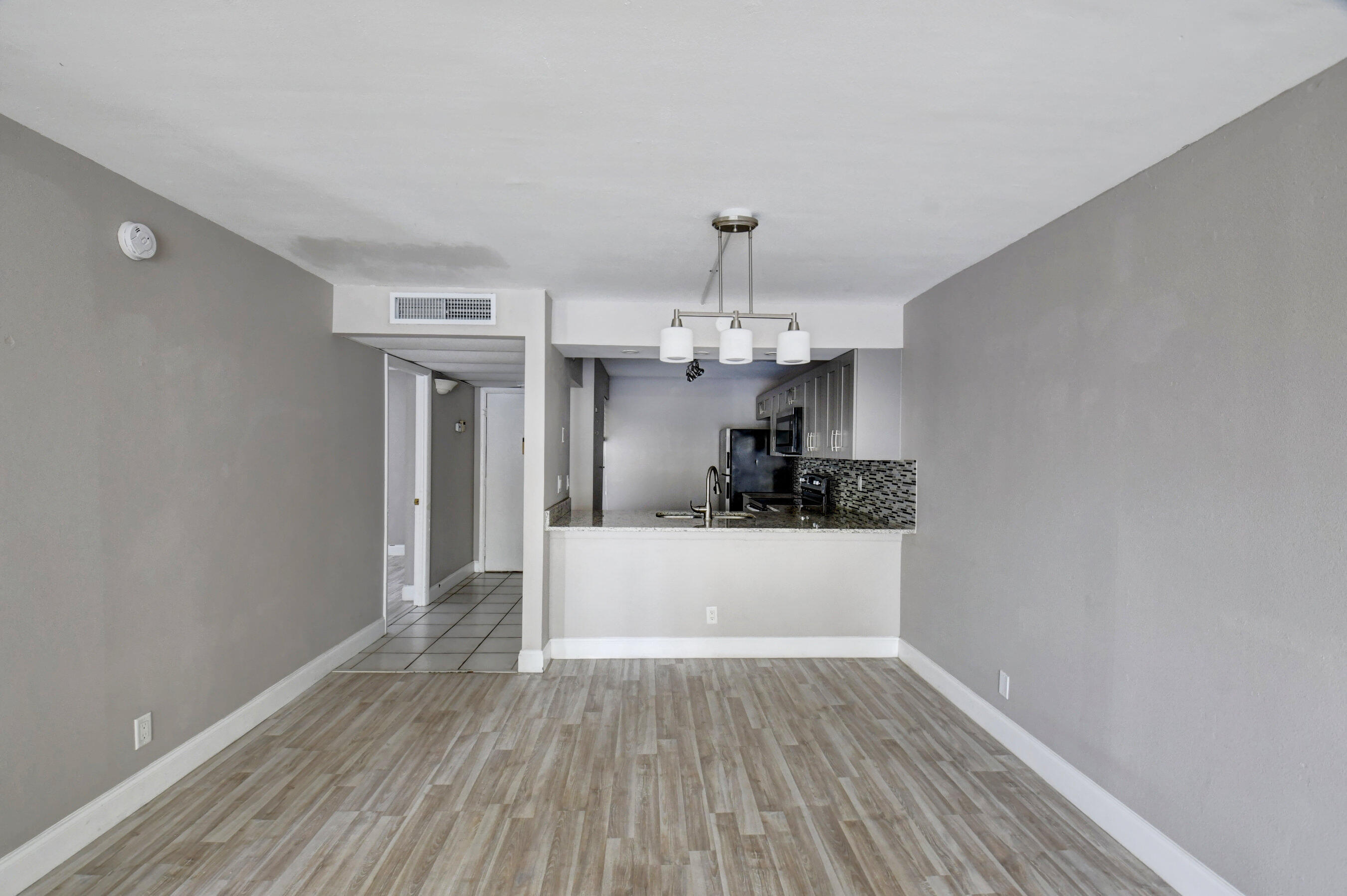 14 Royal Palm Way, Unit 2050 Boca Raton, FL 33432 - Photo 24 of 44 a view of a room with wooden floor and kitchen
