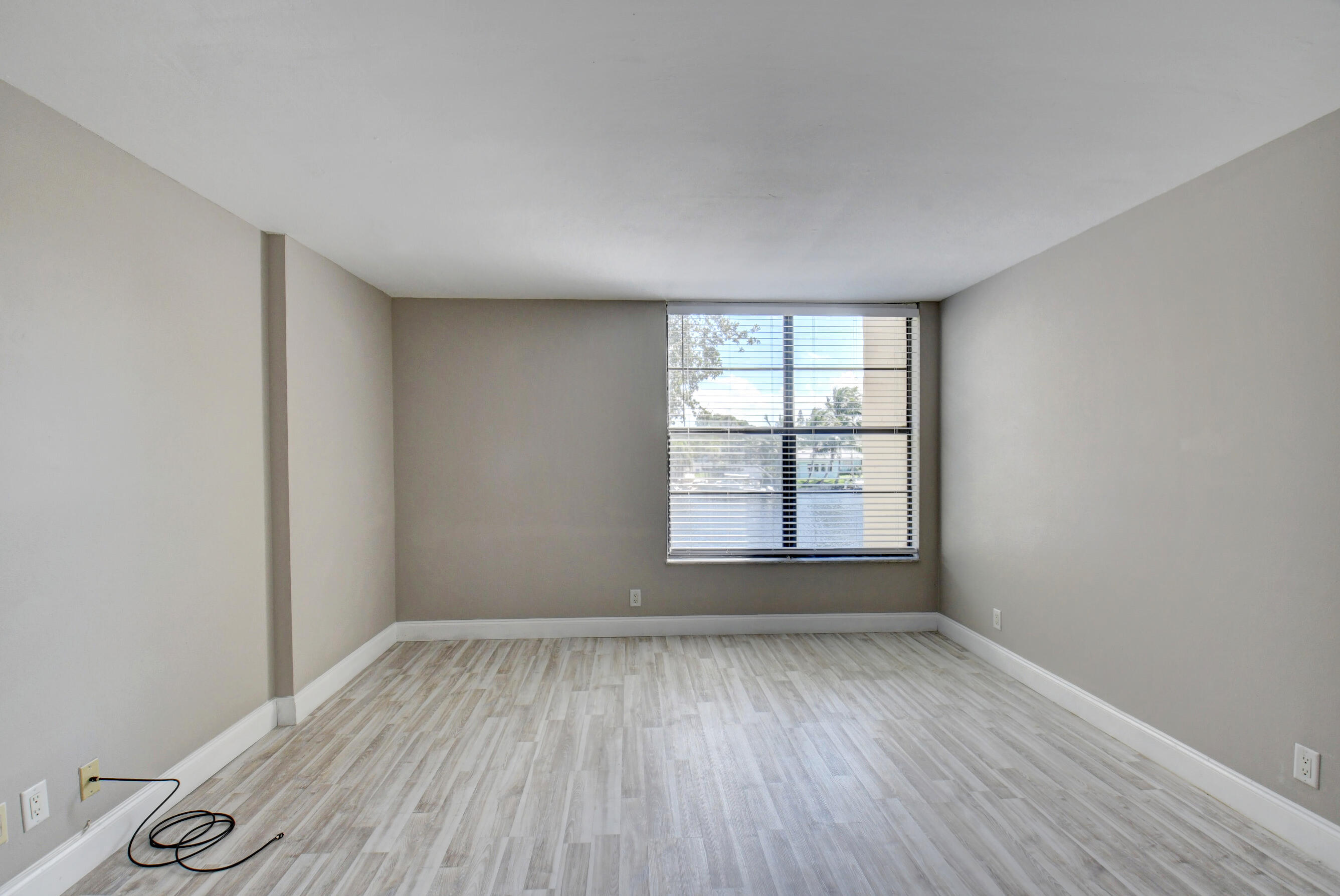 14 Royal Palm Way, Unit 2050 Boca Raton, FL 33432 - Photo 26 of 44 an empty room with wooden floor and windows