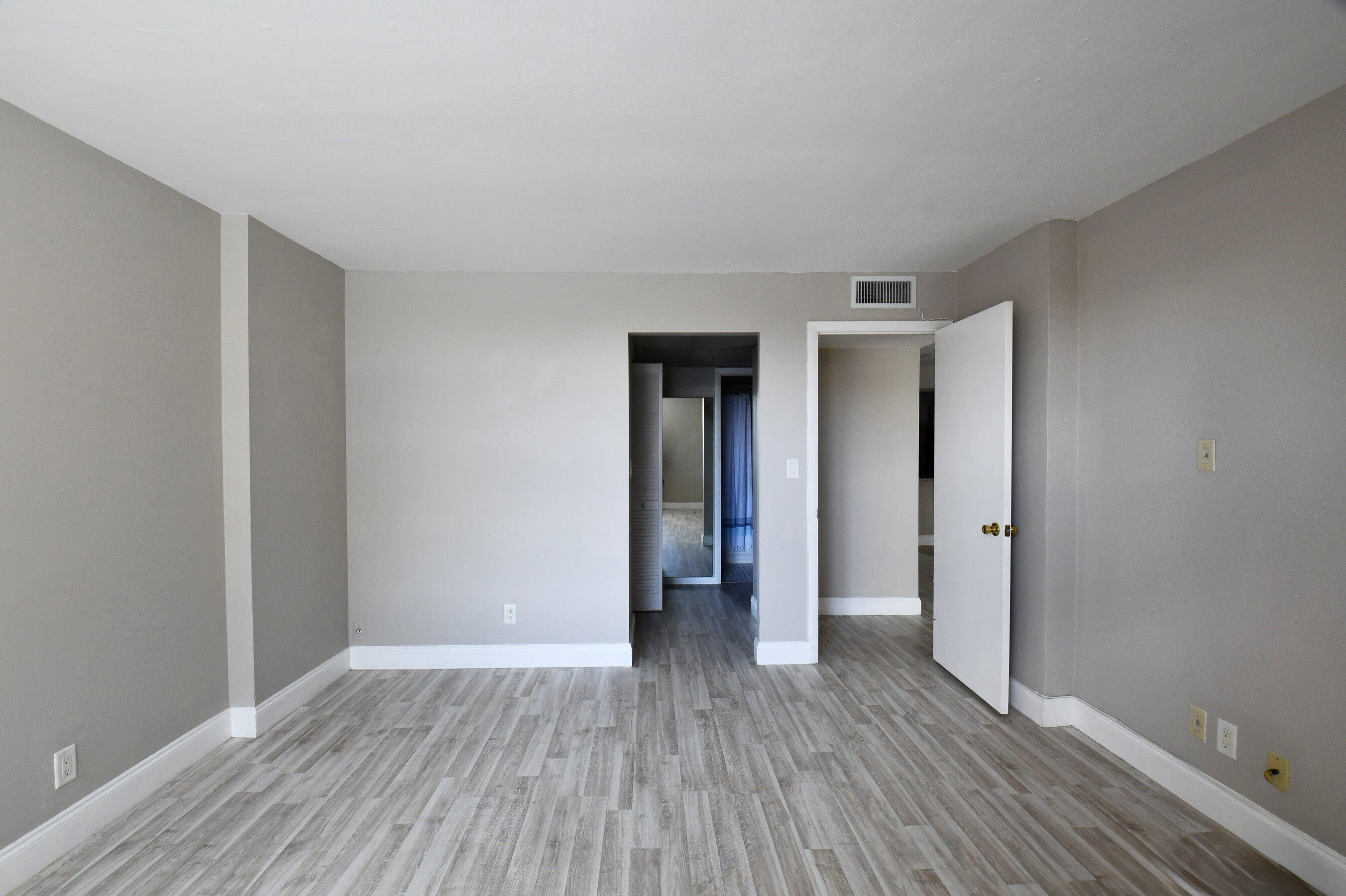14 Royal Palm Way, Unit 2050 Boca Raton, FL 33432 - Photo 27 of 44 a view of an empty room with wooden floor and closet