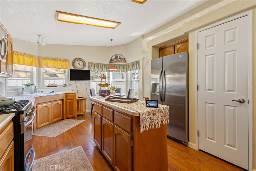4135 Peruvian Way Paso Robles, CA 93446 - Photo 14 of 45 Stainless steel stove, microwave and refrigerator. Closet storage for appliances or jackets.