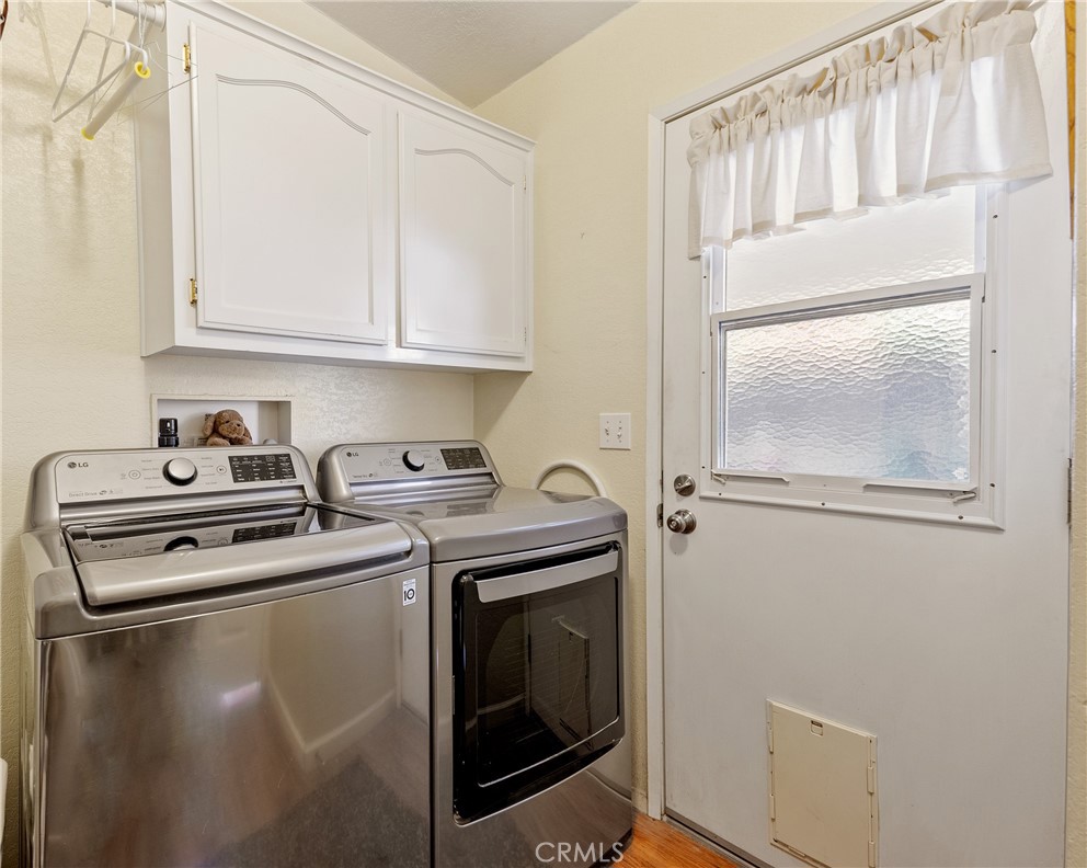 4135 Peruvian Way Paso Robles, CA 93446 - Photo 17 of 45 Laundry room has access to the back deck and also has a deep utility sink ( not pictured) for easy cleanups and there is additional storage too.