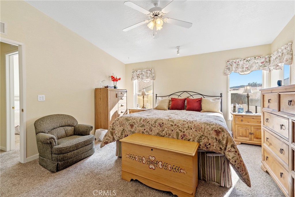 4135 Peruvian Way Paso Robles, CA 93446 - Photo 24 of 45 Primary bedroom with king bed and nice windows. Ceiling fan.