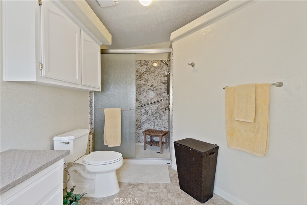 4135 Peruvian Way Paso Robles, CA 93446 - Photo 26 of 45 Primary bathroom has custom built walk in shower with safety bars.