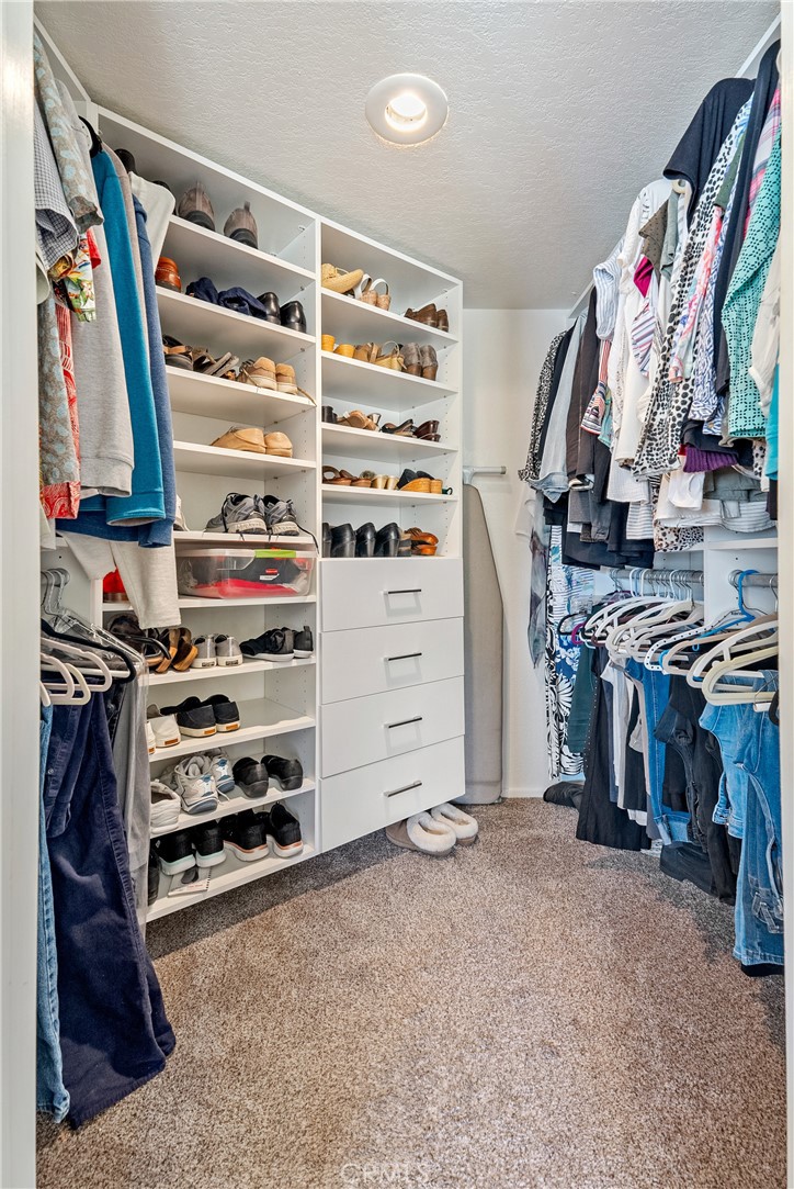 4135 Peruvian Way Paso Robles, CA 93446 - Photo 28 of 45 custom walk in closet by California Closet in primary bedroom