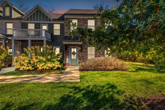 a front view of a house with a garden