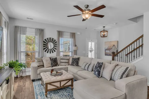 a kitchen with stainless steel appliances granite countertop a stove top oven a sink and white cabinets