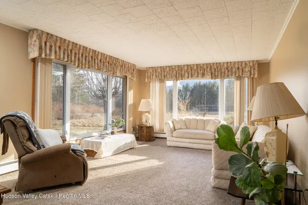 a view of a dining room with furniture and window