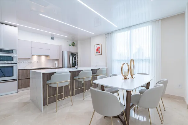 a view of a dining room with furniture and a window