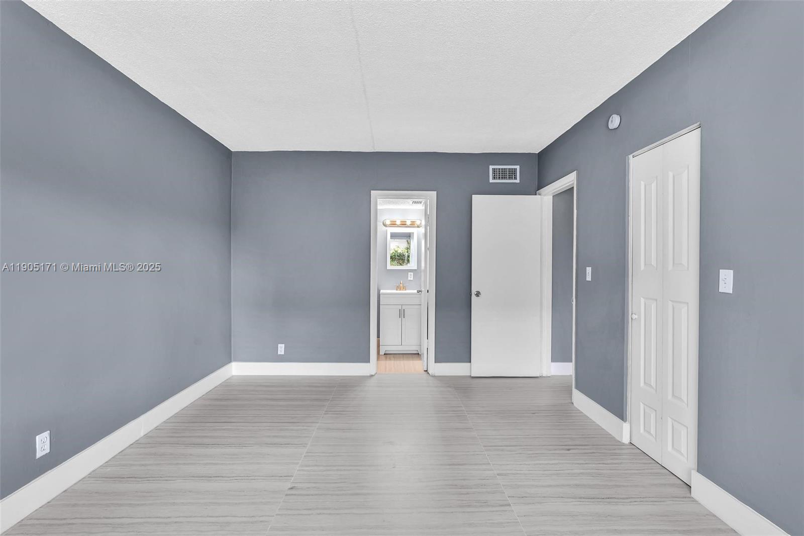 101 Southeast 6th Avenue, Unit 1 Pompano Beach, FL 33060 - Photo 12 of 30 a view of an empty room with wooden floor and closet