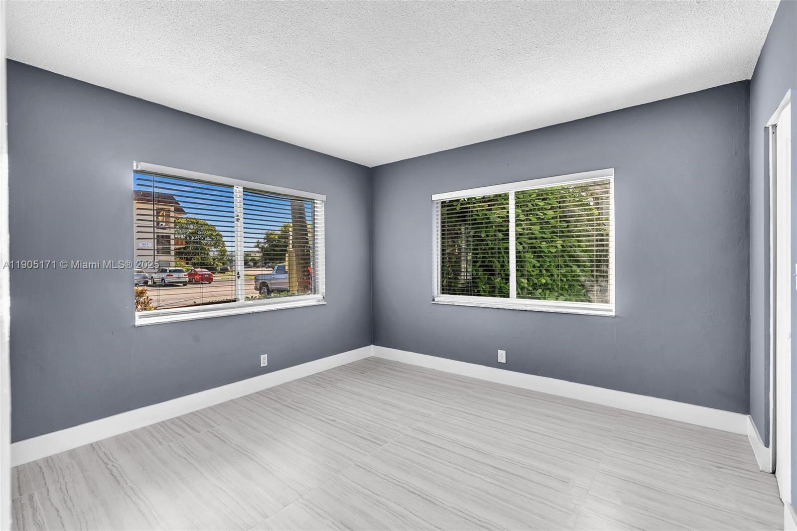 101 Southeast 6th Avenue, Unit 1 Pompano Beach, FL 33060 - Photo 17 of 30 a view of an empty room with wooden floor and a window