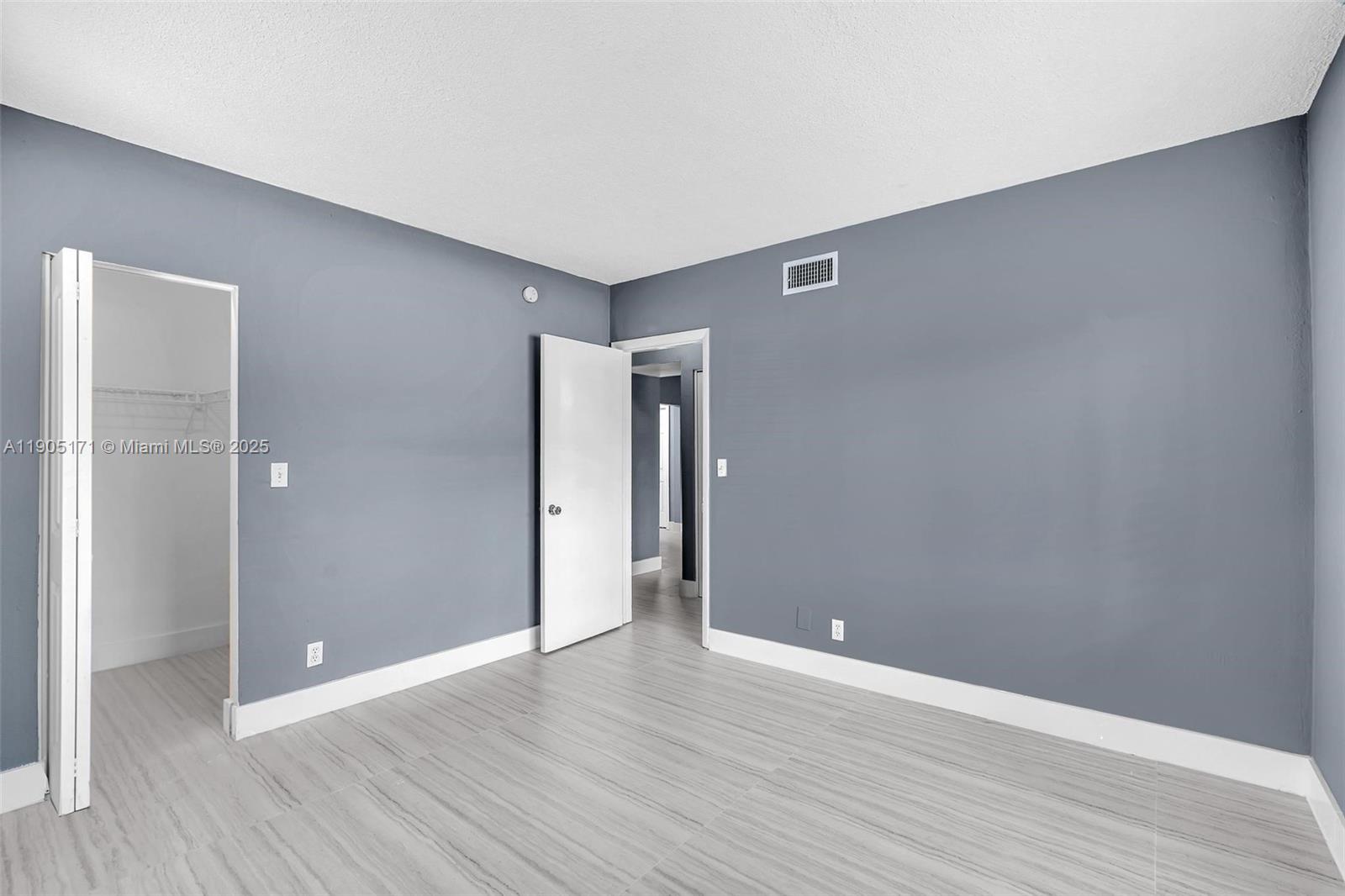 101 Southeast 6th Avenue, Unit 1 Pompano Beach, FL 33060 - Photo 19 of 30 a view of an empty room with wooden floor
