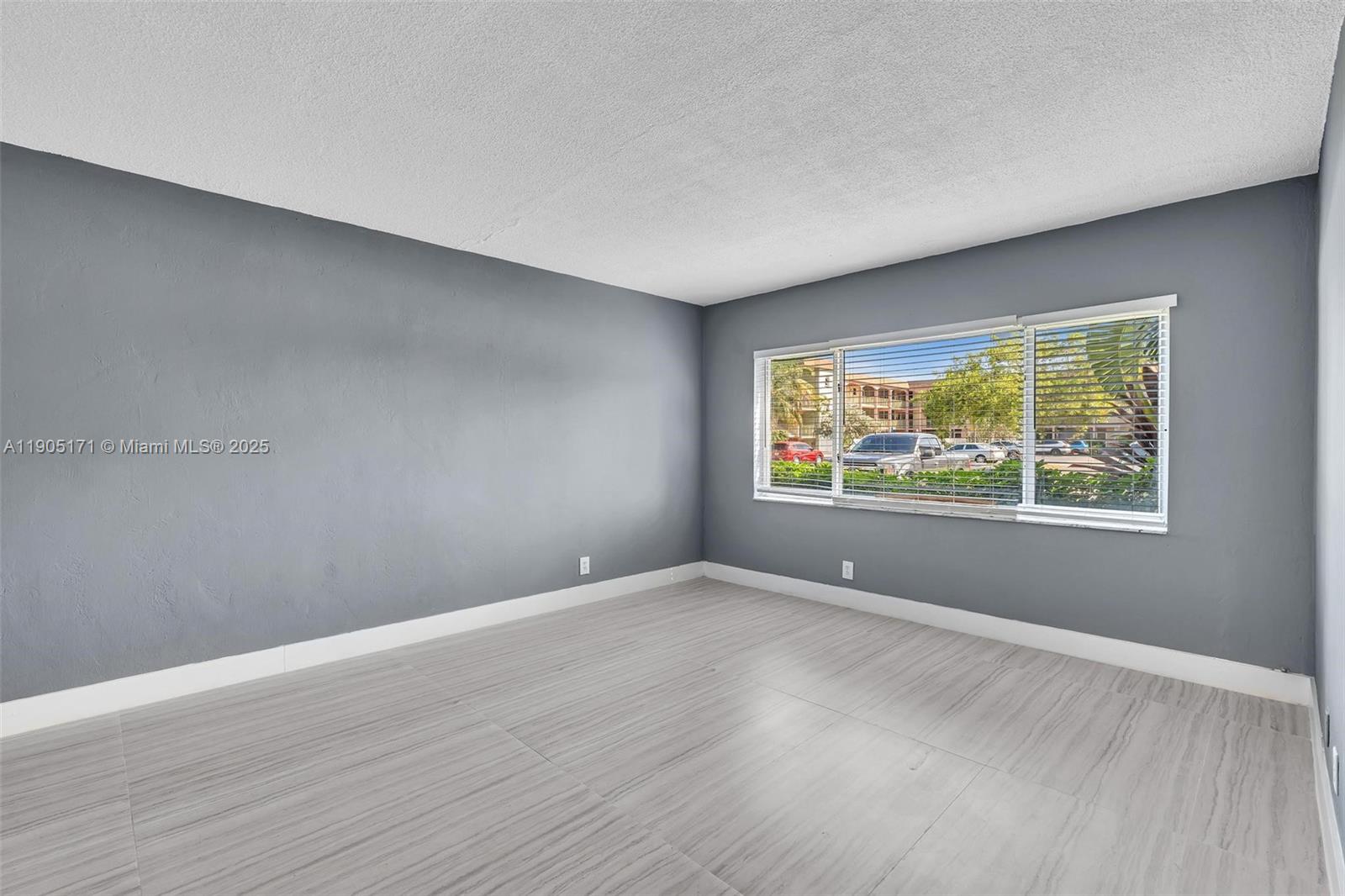 101 Southeast 6th Avenue, Unit 1 Pompano Beach, FL 33060 - Photo 22 of 30 a view of an empty room with wooden floor and a window