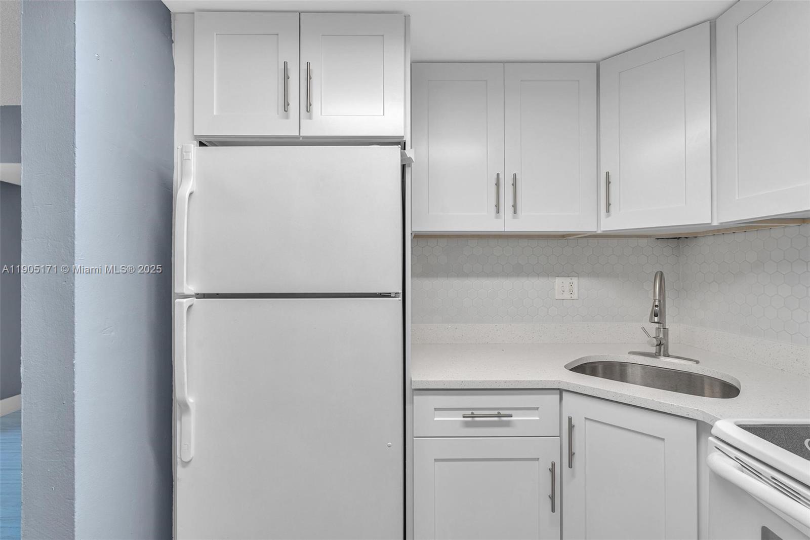 101 Southeast 6th Avenue, Unit 1 Pompano Beach, FL 33060 - Photo 4 of 30 a kitchen with a refrigerator and a sink