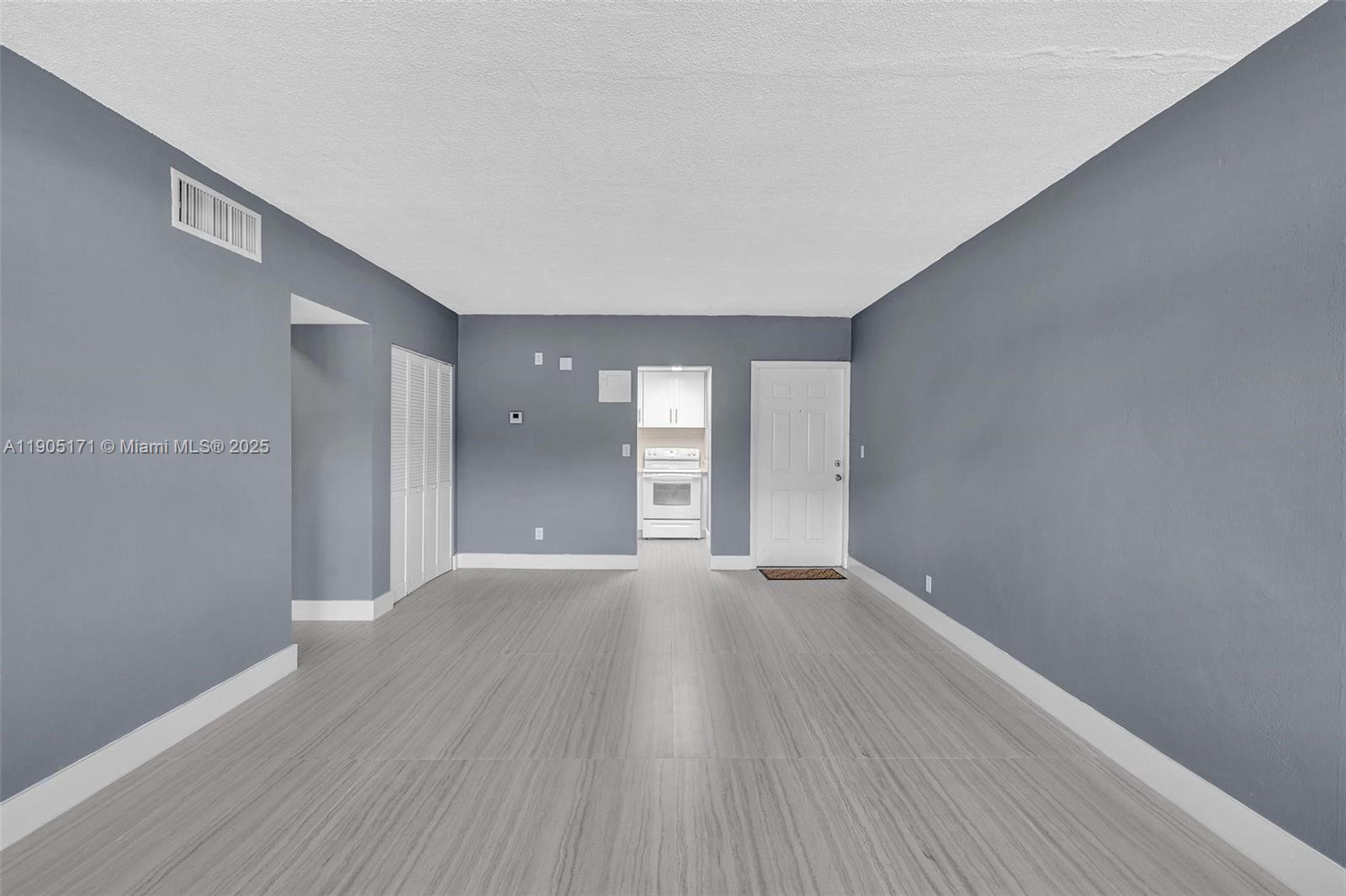 101 Southeast 6th Avenue, Unit 1 Pompano Beach, FL 33060 - Photo 9 of 30 a view of an empty room with window and wooden floor