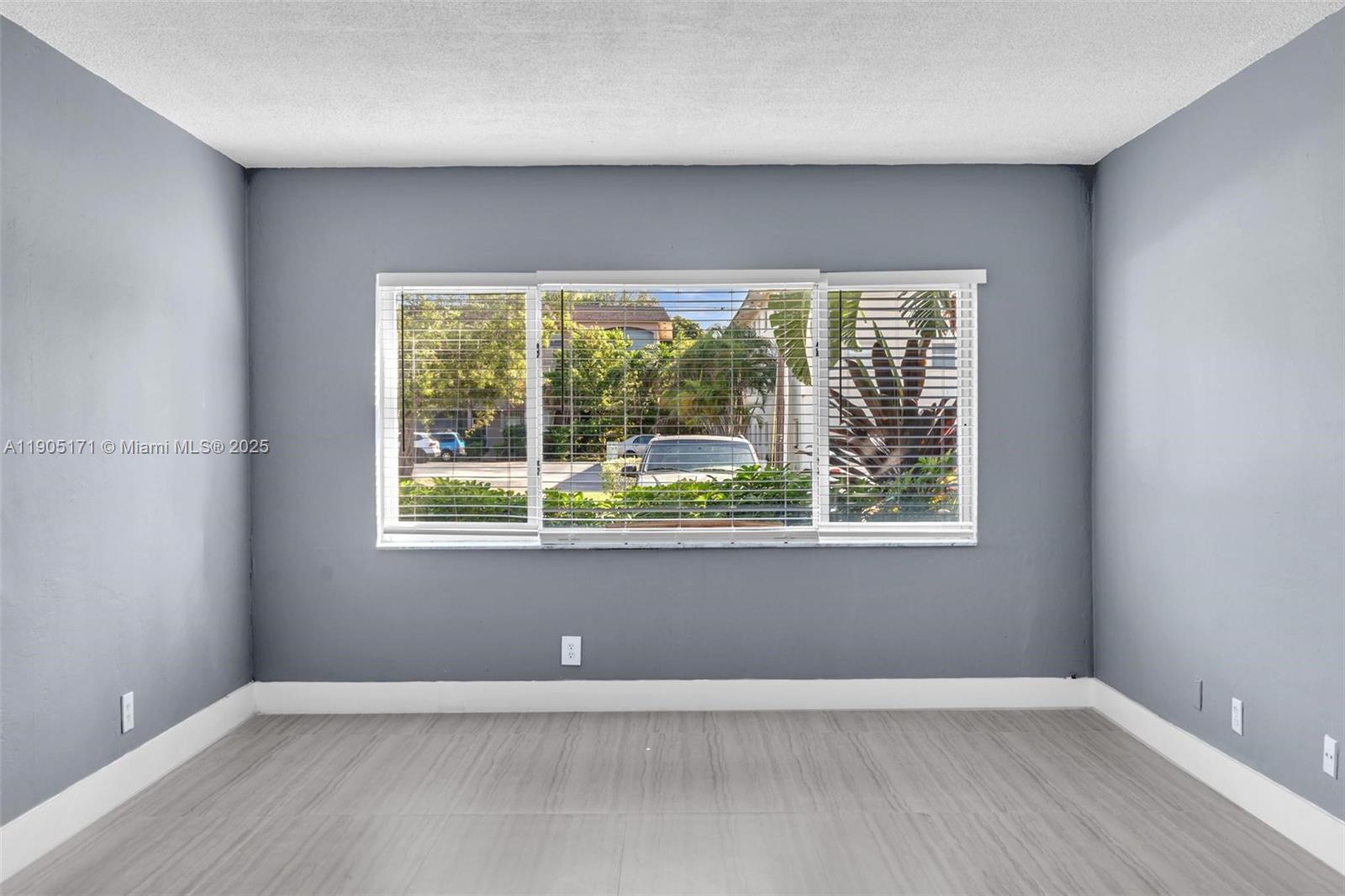 101 Southeast 6th Avenue, Unit 1 Pompano Beach, FL 33060 - Photo 10 of 30 an empty room with wooden floor and a window