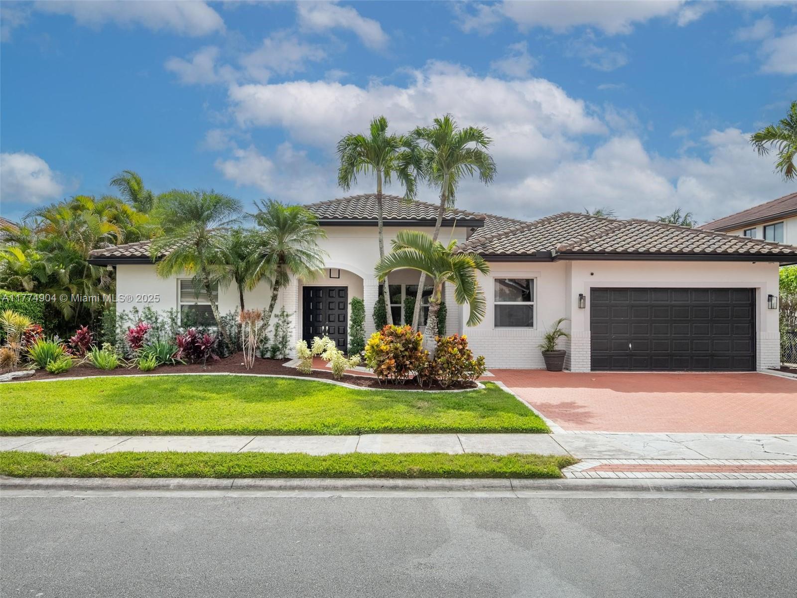 373 Southwest 159th Lane Pembroke Pines, FL 33027 - Photo 1 of 42 a front view of a house with a yard table and chairs