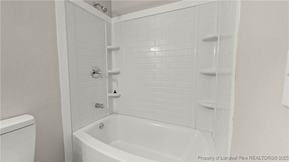 164 Happy Valley Road West End, NC 27376 - Photo 11 of 17 a white bath tub sitting next to a toilet